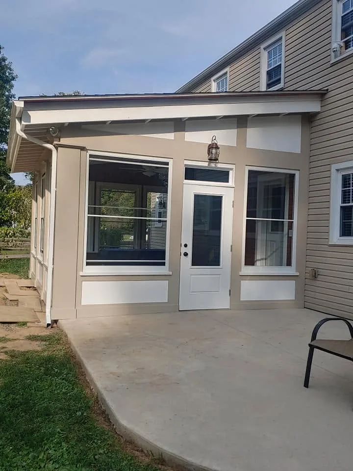 The porch door and transom, seen from the concrete patio