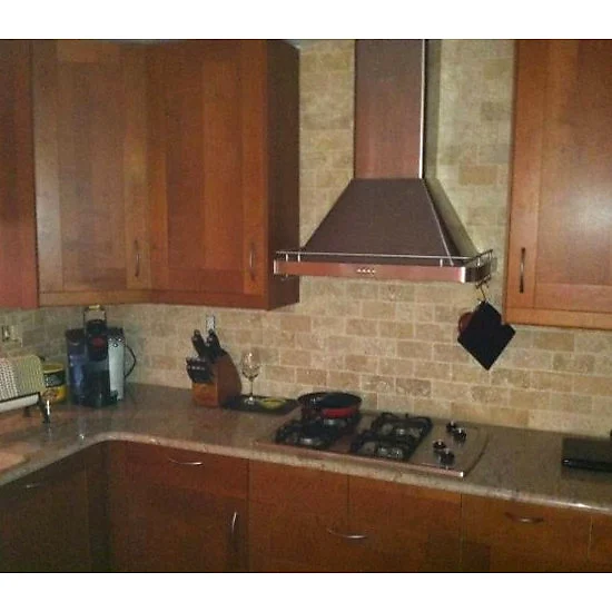 Cherry kitchen with a stacked-stone backsplash and glass cabinet fronts