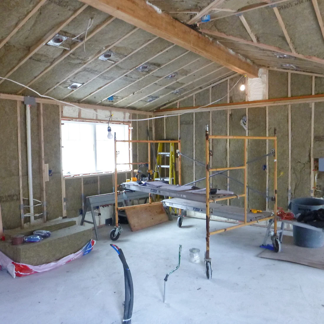 Interior of the same addition, framing fully insulated and ready for drywall